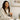 Smiling woman in a plush robe enjoying a tea at Botanica Wellness Spa and Clinic, capturing the calm and care of a Mother’s Day spa experience.