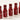 Five red O COSMEDICS bottles in a row on a cream background